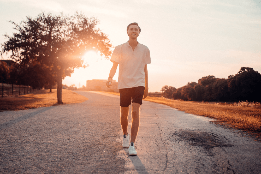 man wearing white shirt and black shorts walking