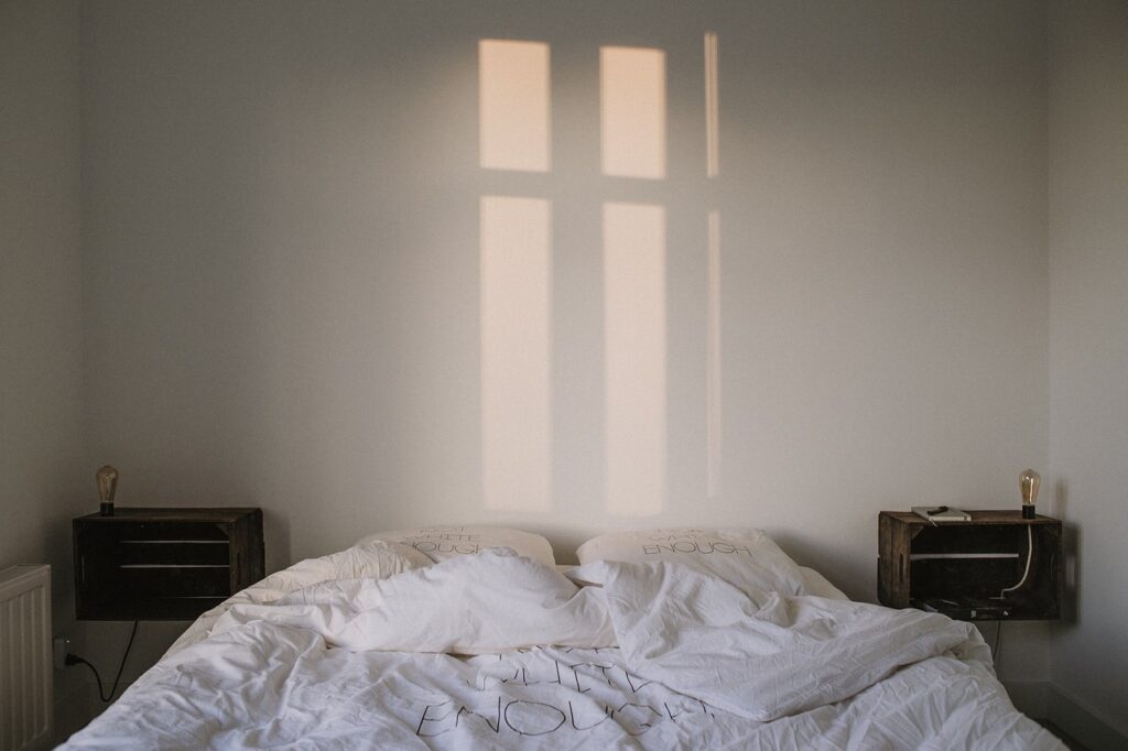 Bed with reflection of window on wall