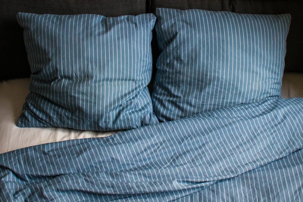 Blue stripe pillow on bed