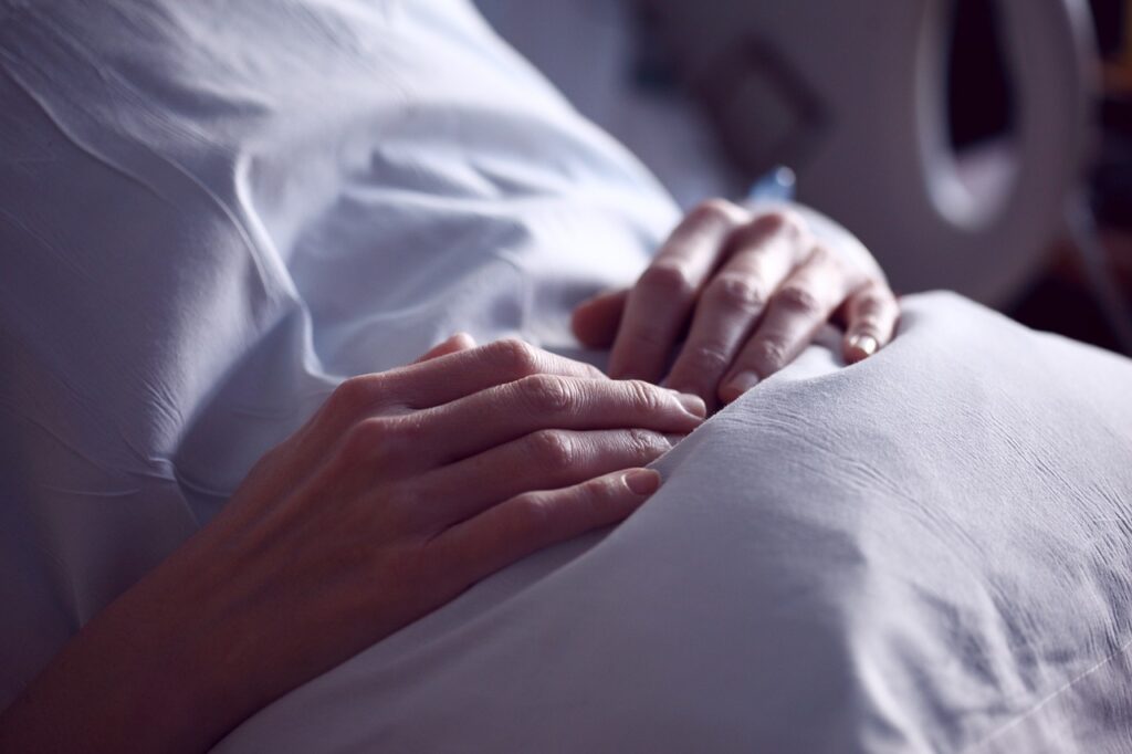 Woman arms hugging pillow