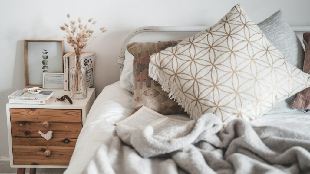 White and Brown Throw Pillow on White Bed